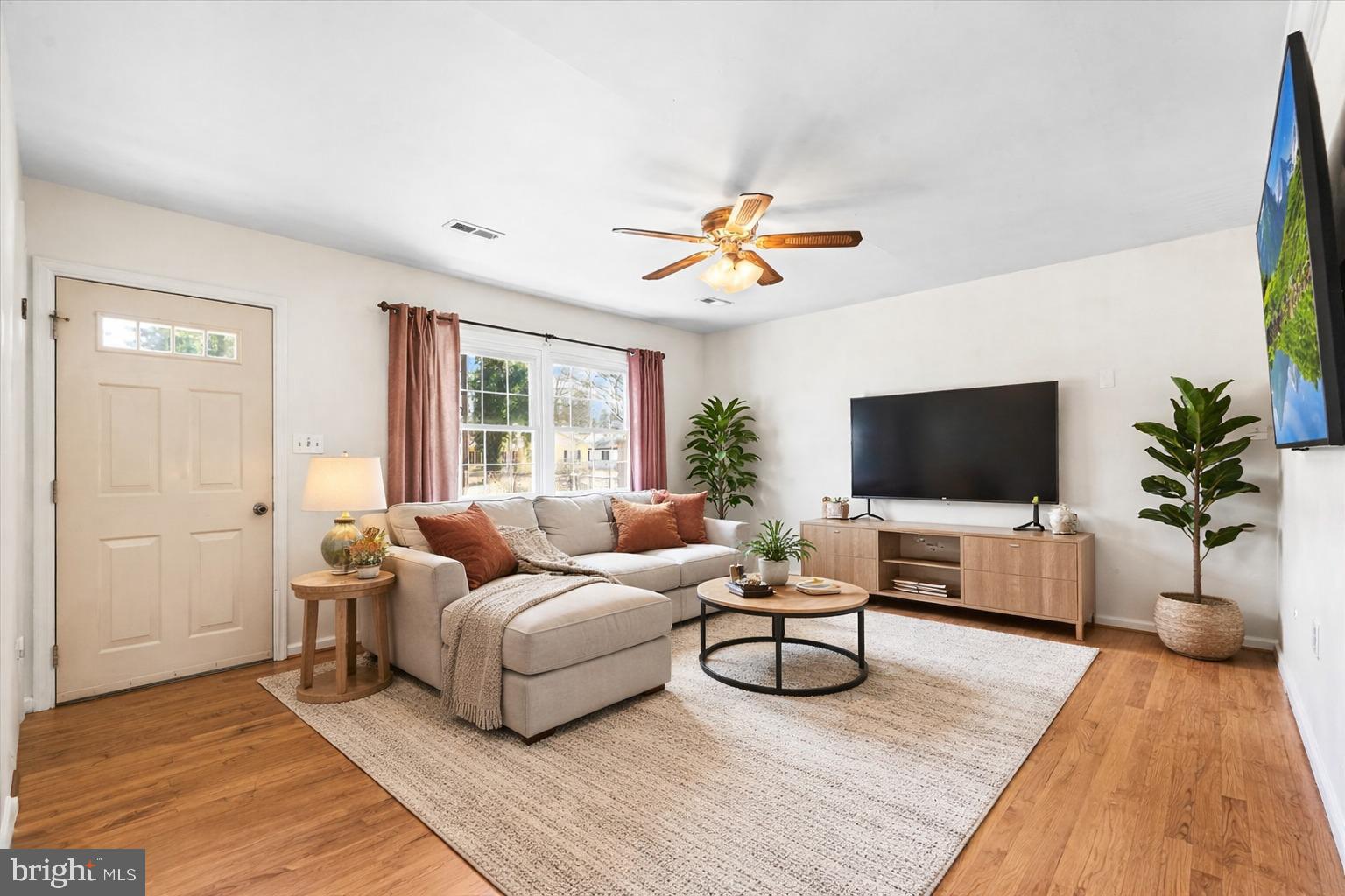 227 7th Street Colonial Beach, VA 22443 - Photo 7 of 36 a living room with furniture and a flat screen tv