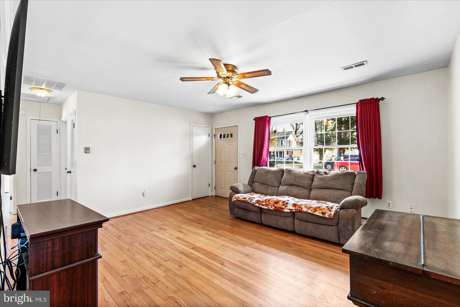 227 7th Street Colonial Beach, VA 22443 - Photo 8 of 36 a living room with furniture and a ceiling fan