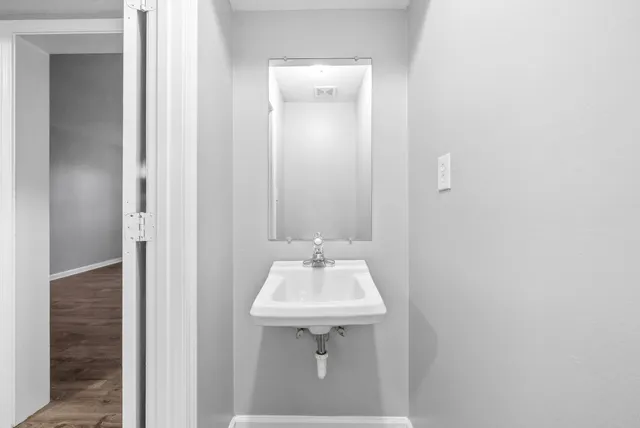 a bathroom with a sink a mirror and vanity
