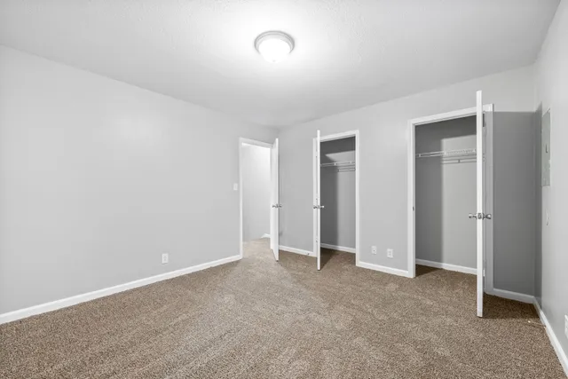 an empty room with closet area