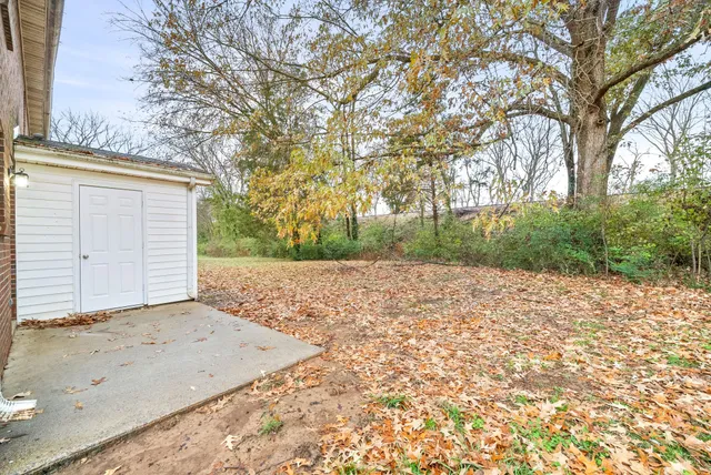 a view of a backyard of the house