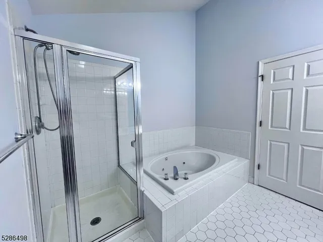 a white bath tub sitting next to a shower