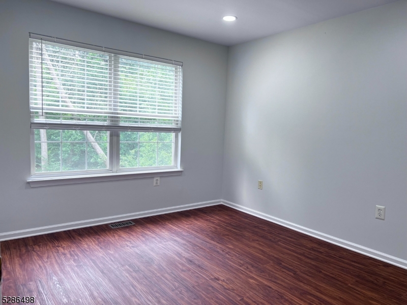 128 Constitution Way Bernards, NJ 07920 - Photo 16 of 26 a view of an empty room with wooden floor and a window