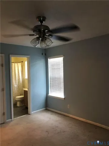 a view of a livingroom with a ceiling fan and window