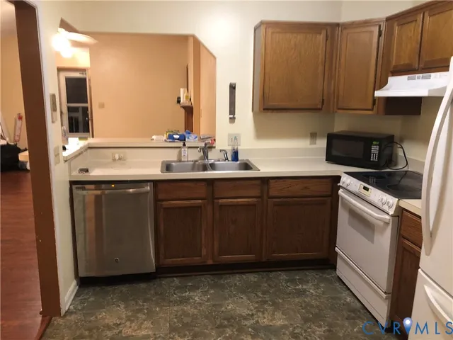 a kitchen with a sink stove and cabinets