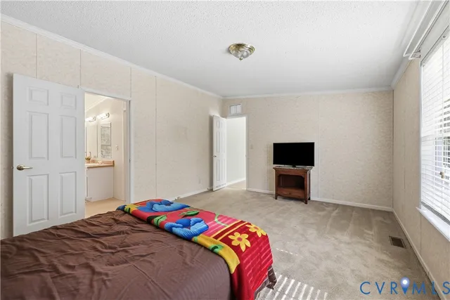 a bedroom with a bed and a television