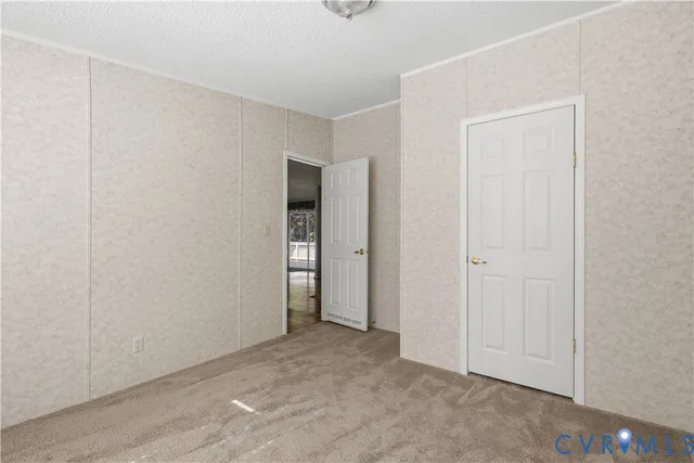 a view of an empty room with closet area