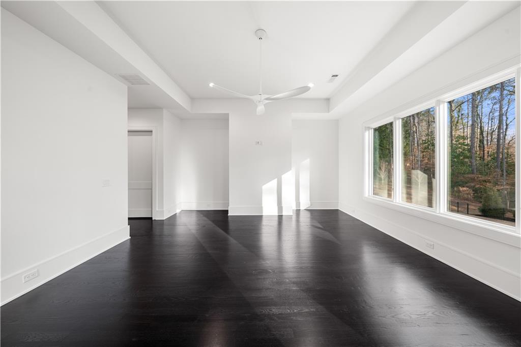 5211 Powers Ferry Road Northwest Sandy Springs, GA 30327 - Photo 90 of 106 a view of an empty room with wooden floor and a window