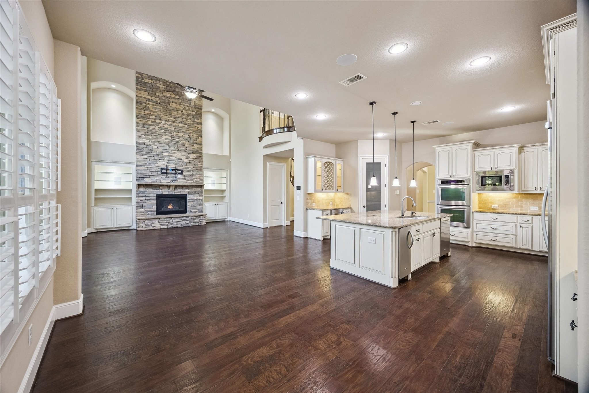 35 North Fremont Ridge Loop Spring, TX 77389 - Photo 37 of 37 The thoughtfully designed open-concept floor plan creates a seamless flow between the kitchen, breakfast area, and family room. A stunning floor-to-ceiling stone fireplace serves as the focal point, while the walk-in pantry and butler's pantry enhance both functionality and entertaining.
