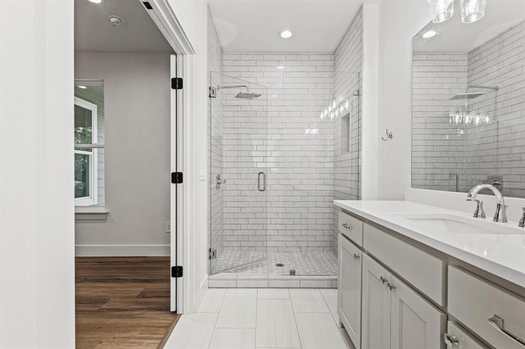 508 Florence Denison, TX 75020 - Photo 17 of 26 a bathroom with a shower sink and mirror
