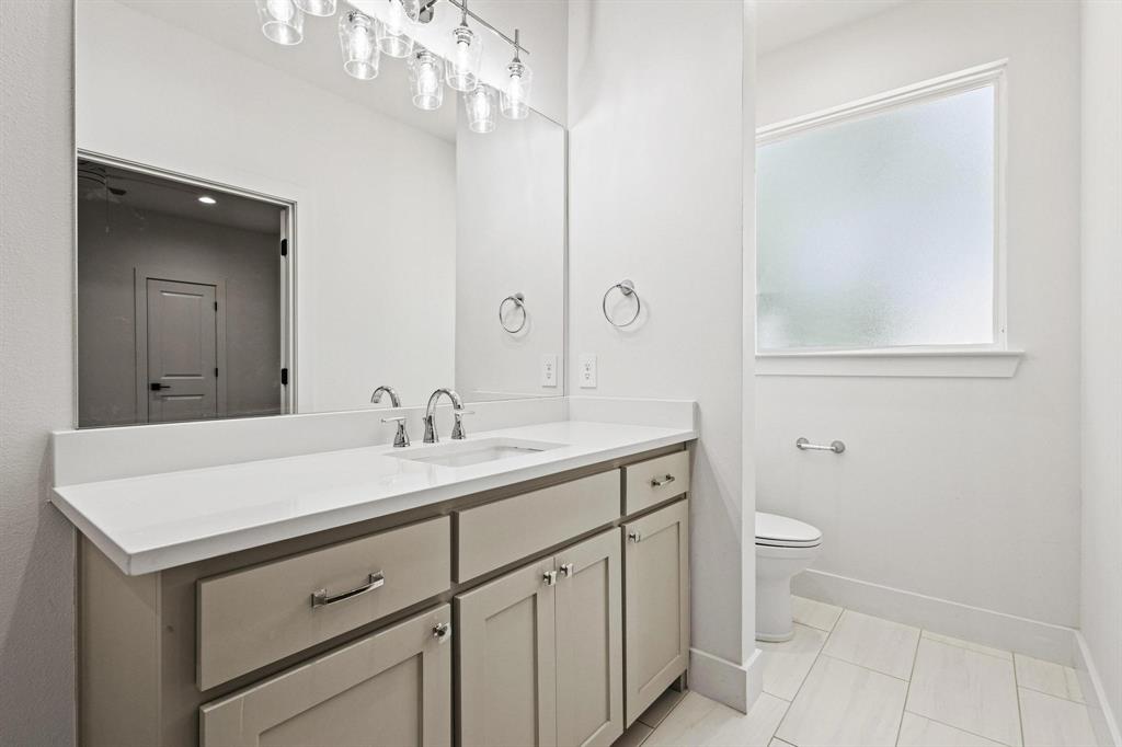 508 Florence Denison, TX 75020 - Photo 18 of 26 a bathroom with a sink a toilet and a mirror