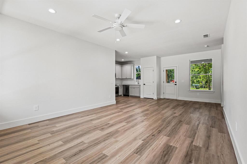 508 Florence Denison, TX 75020 - Photo 5 of 26 an empty room with windows and a fireplace