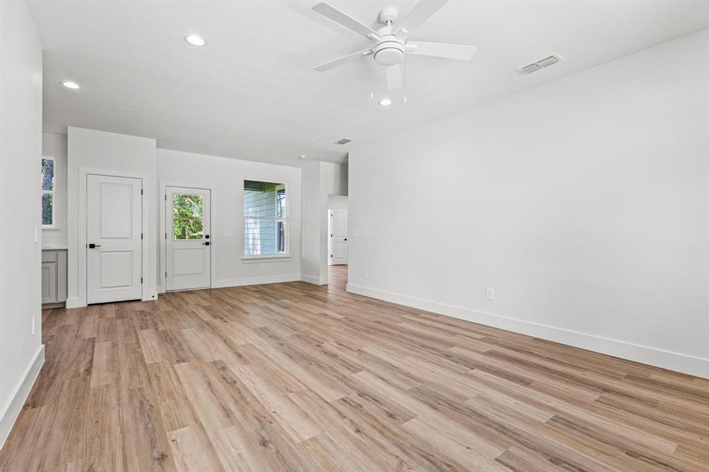508 Florence Denison, TX 75020 - Photo 6 of 26 an empty room with wooden floor closet and windows
