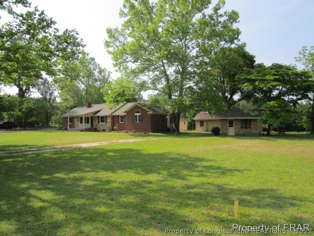 1373 Joel Road Carthage, NC 28327 - Photo 22 of 27 a front view of a house with a garden