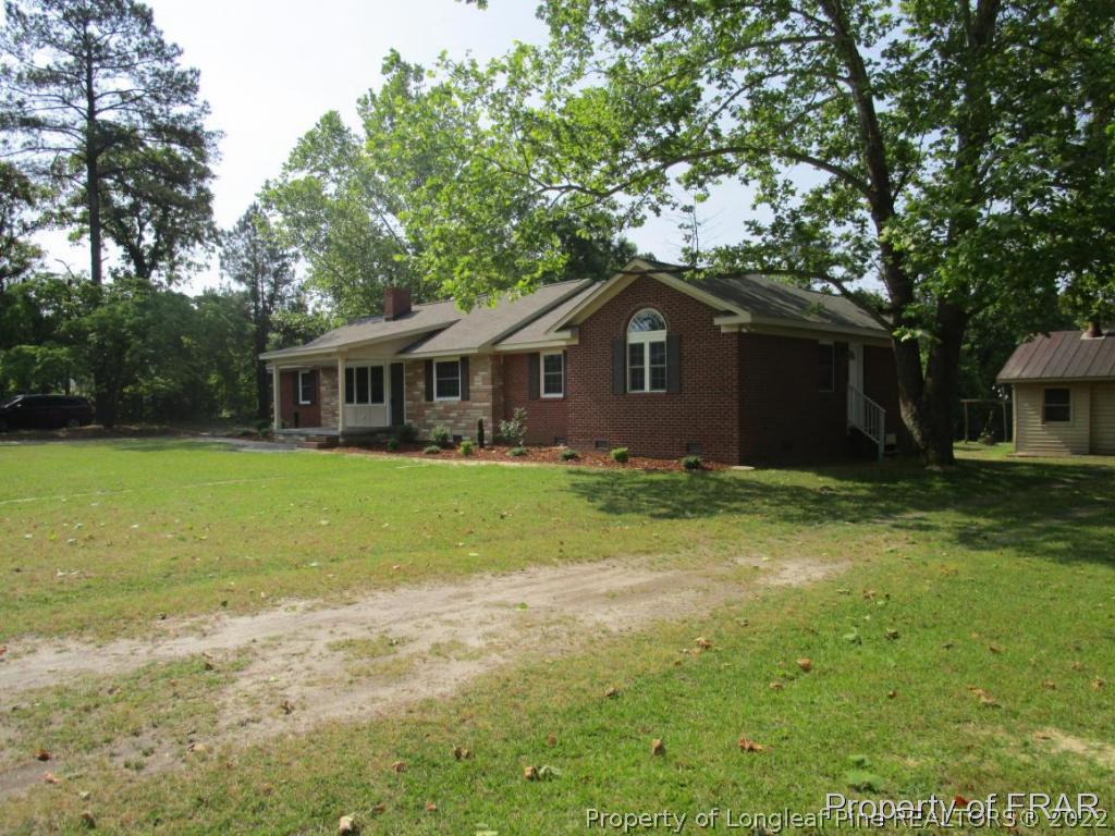 1373 Joel Road Carthage, NC 28327 - Photo 23 of 27 a front view of a house with garden