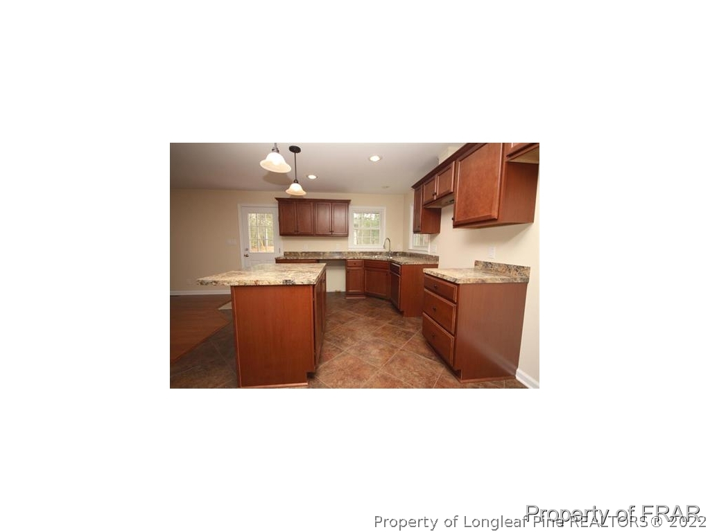 1373 Joel Road Carthage, NC 28327 - Photo 7 of 27 a kitchen with a sink a counter top space and stainless steel appliances