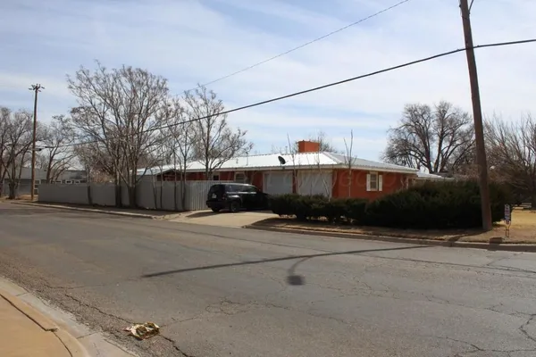 a front view of a house with a road