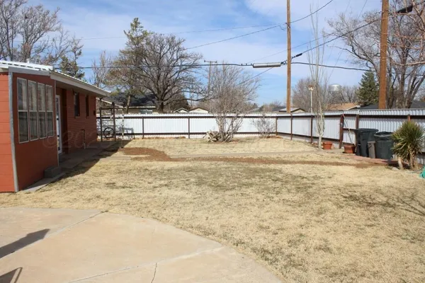 a view of a house with chairs in the patio