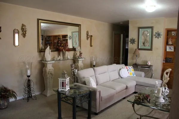 a living room with furniture and a mirror