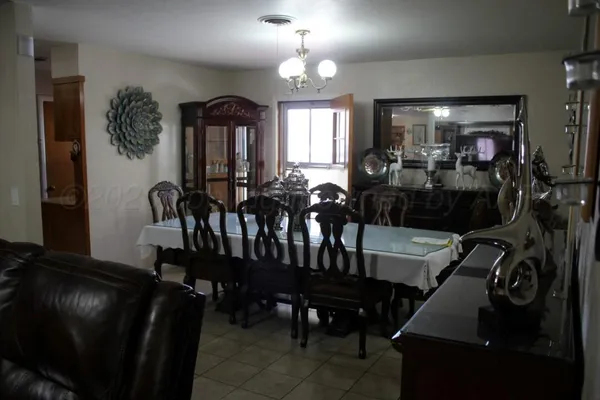 a view of a dining room with furniture and chandelier