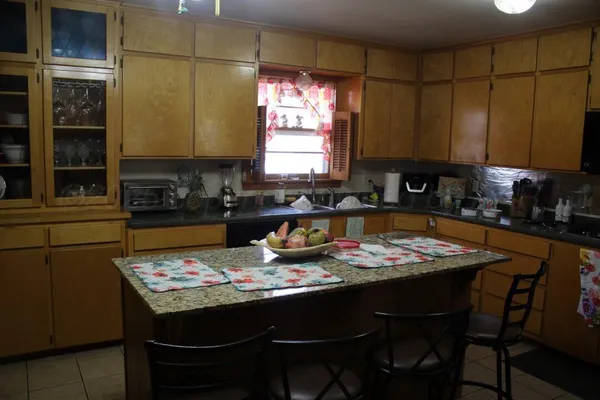 a kitchen with a stove a sink and a refrigerator