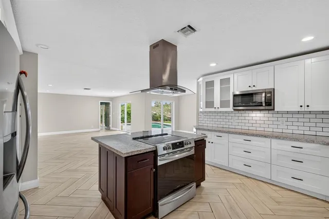 a kitchen with granite countertop a stove and a sink