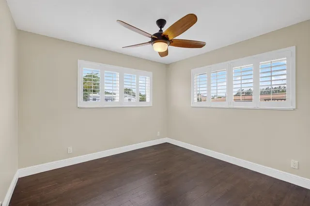 a view of a livingroom with a ceiling fan and a large window