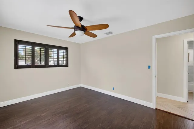a view of a room with wooden floor and windows