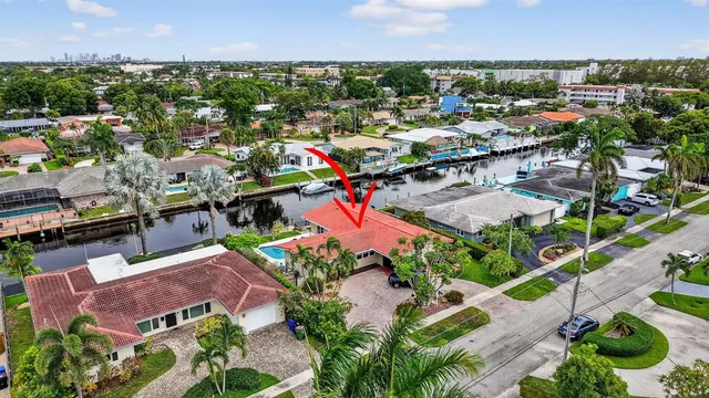 an aerial view of residential houses with outdoor space and swimming pool