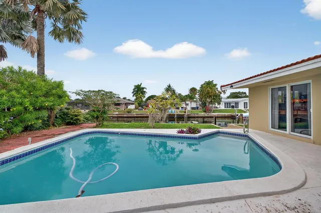 a view of outdoor space with swimming pool and seating