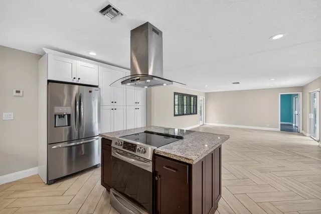 a kitchen with granite countertop a sink and stainless steel appliances