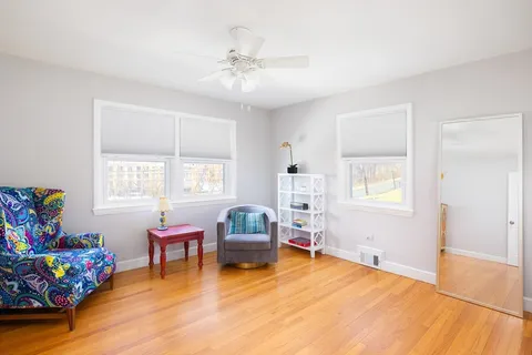 a bedroom with furniture and a wooden floor