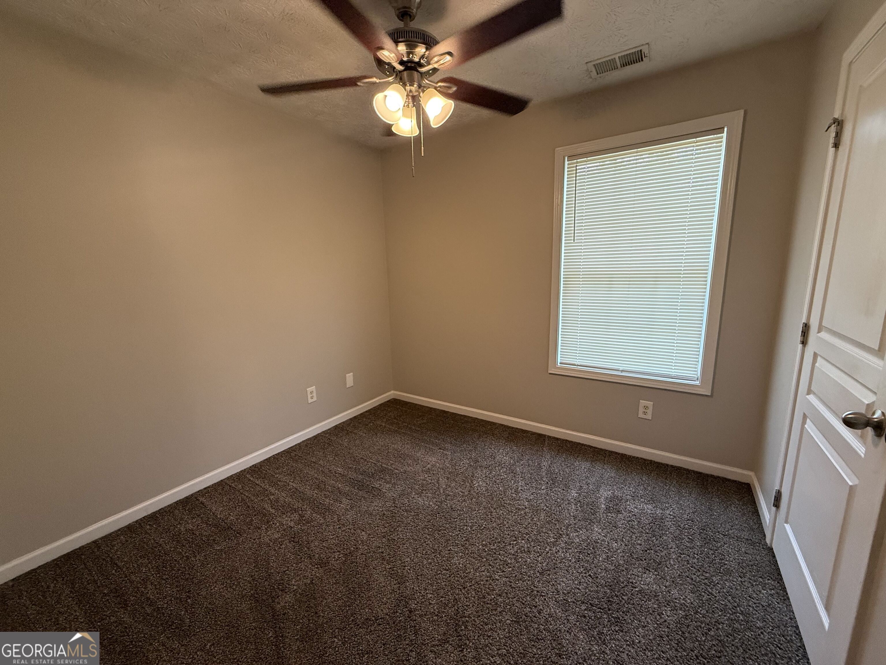 6132 Ruth Street Southwest Covington, GA 30014 - Photo 15 of 33 an empty room with a window and a fan