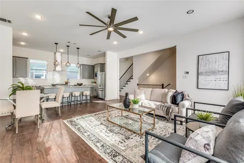 a living room with furniture and kitchen view