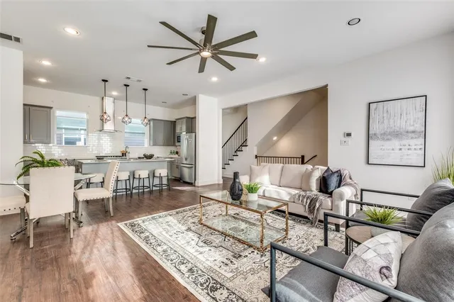 a living room with furniture and kitchen view