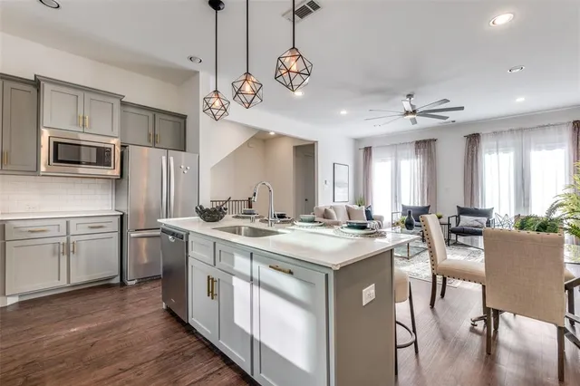 a kitchen with a stove kitchen island and stainless steel appliances