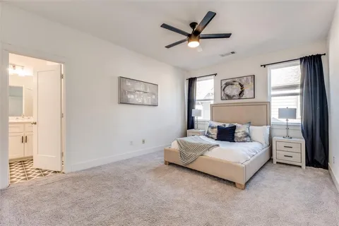 a bedroom with a bed painting on the wall and a window