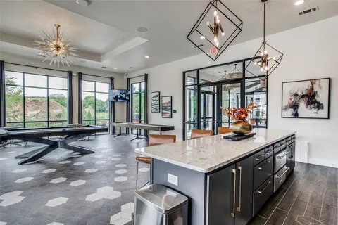 a living room with furniture a rug and a floor to ceiling window