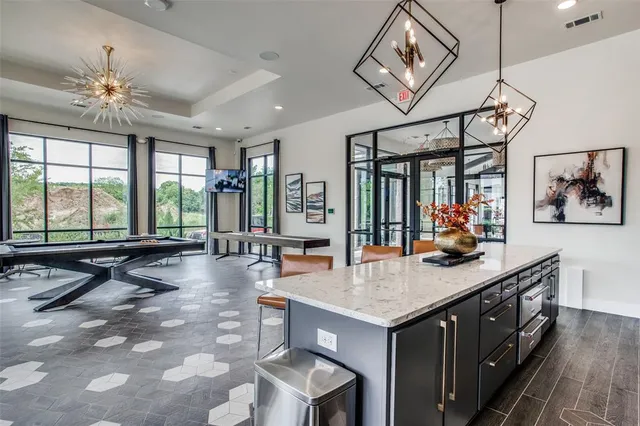a living room with furniture a rug and a floor to ceiling window