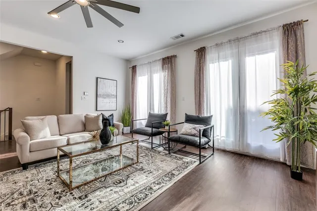 a living room with furniture and large windows