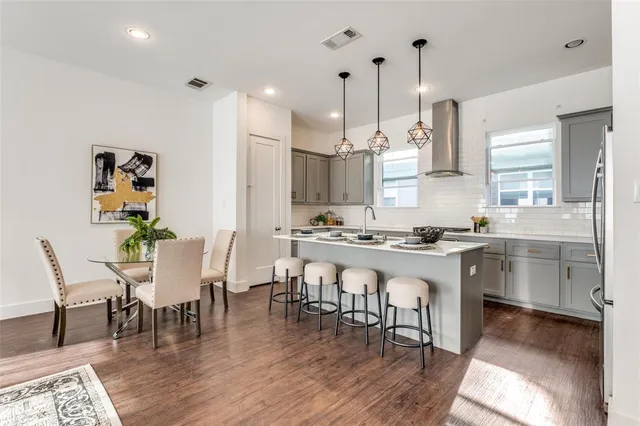 a large kitchen with a table and chairs