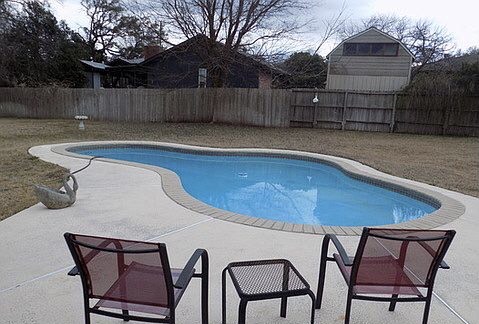 509 Meadowbrook Drive Georgetown, TX 78628 - Photo 2 of 17 An inviting backyard features a shimmering in-ground pool, perfect for leisure.