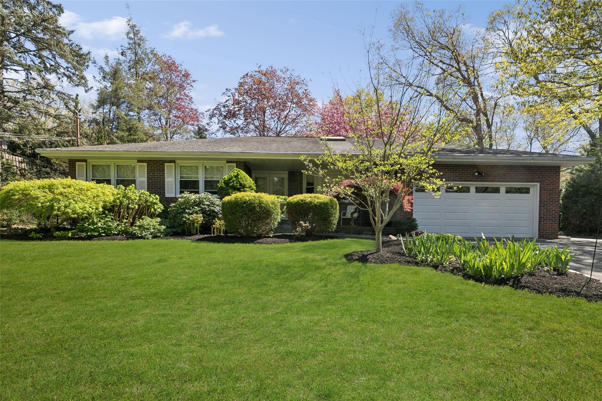 70 Woodchuck Hollow Road Cold Spring Harbor, NY 11724 - Photo 1 of 1 Ranch-style home featuring brick siding, a garage, a front lawn, and driveway