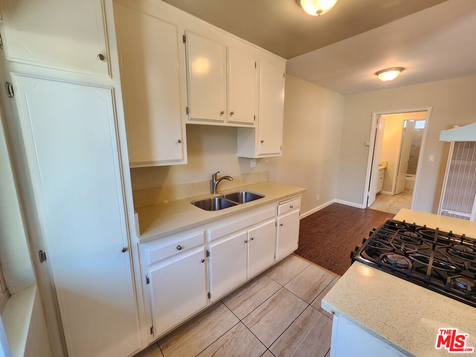 7925 Vineland Avenue, Unit 26 Los Angeles, CA 91352 - Photo 13 of 34 a kitchen with sink stove and cabinets