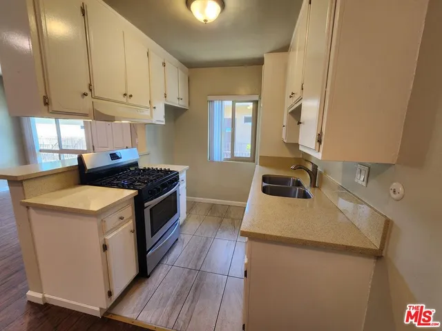 a kitchen that has a sink and a stove