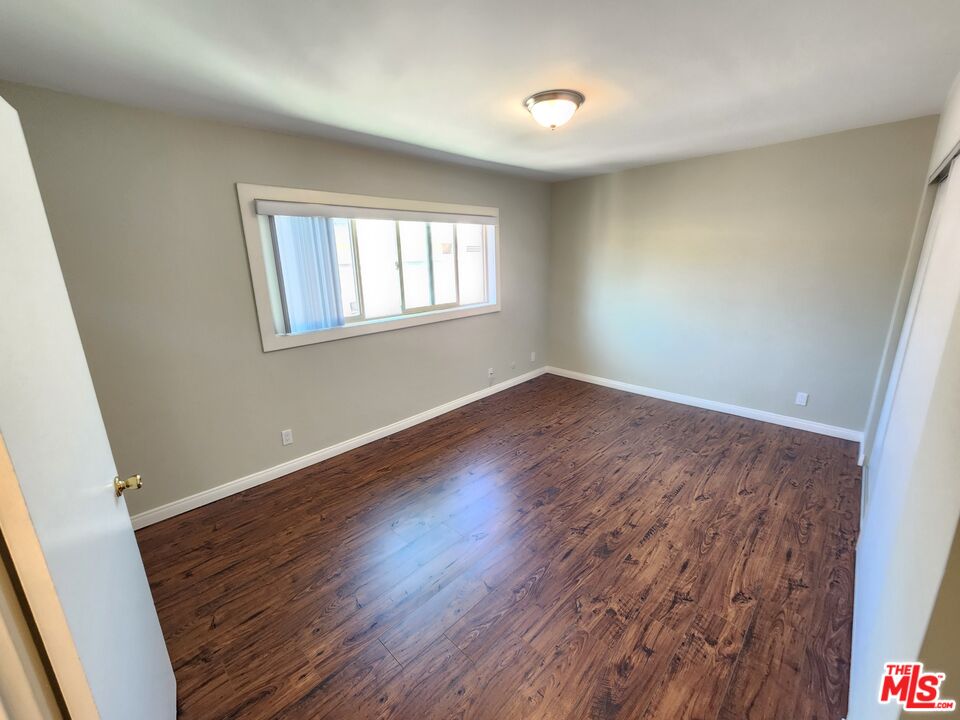 7925 Vineland Avenue, Unit 26 Los Angeles, CA 91352 - Photo 19 of 34 wooden floor in an empty room with a window