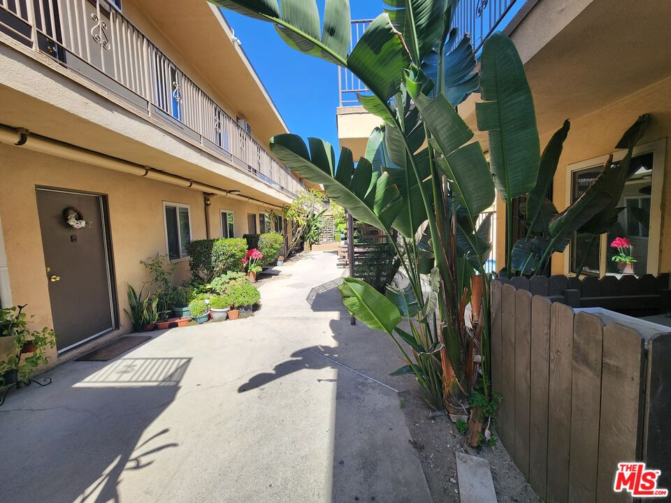 7925 Vineland Avenue, Unit 26 Los Angeles, CA 91352 - Photo 29 of 34 a view of a pathway of a house with wooden fence