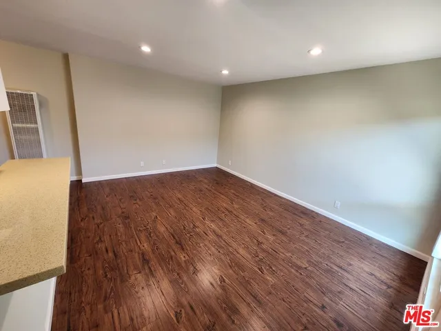 an empty room with wooden floor