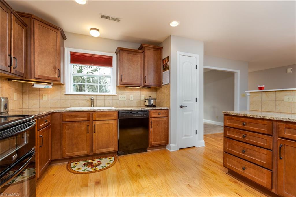 3713 Pride's Road East Bend, NC 27018 - Photo 4 of 29 Custom cabinets with space saving pull outs and plenty of counter space!