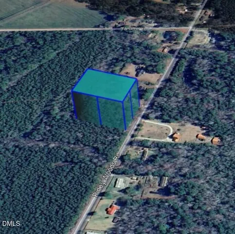 a backyard of a house with lots of plants and trees